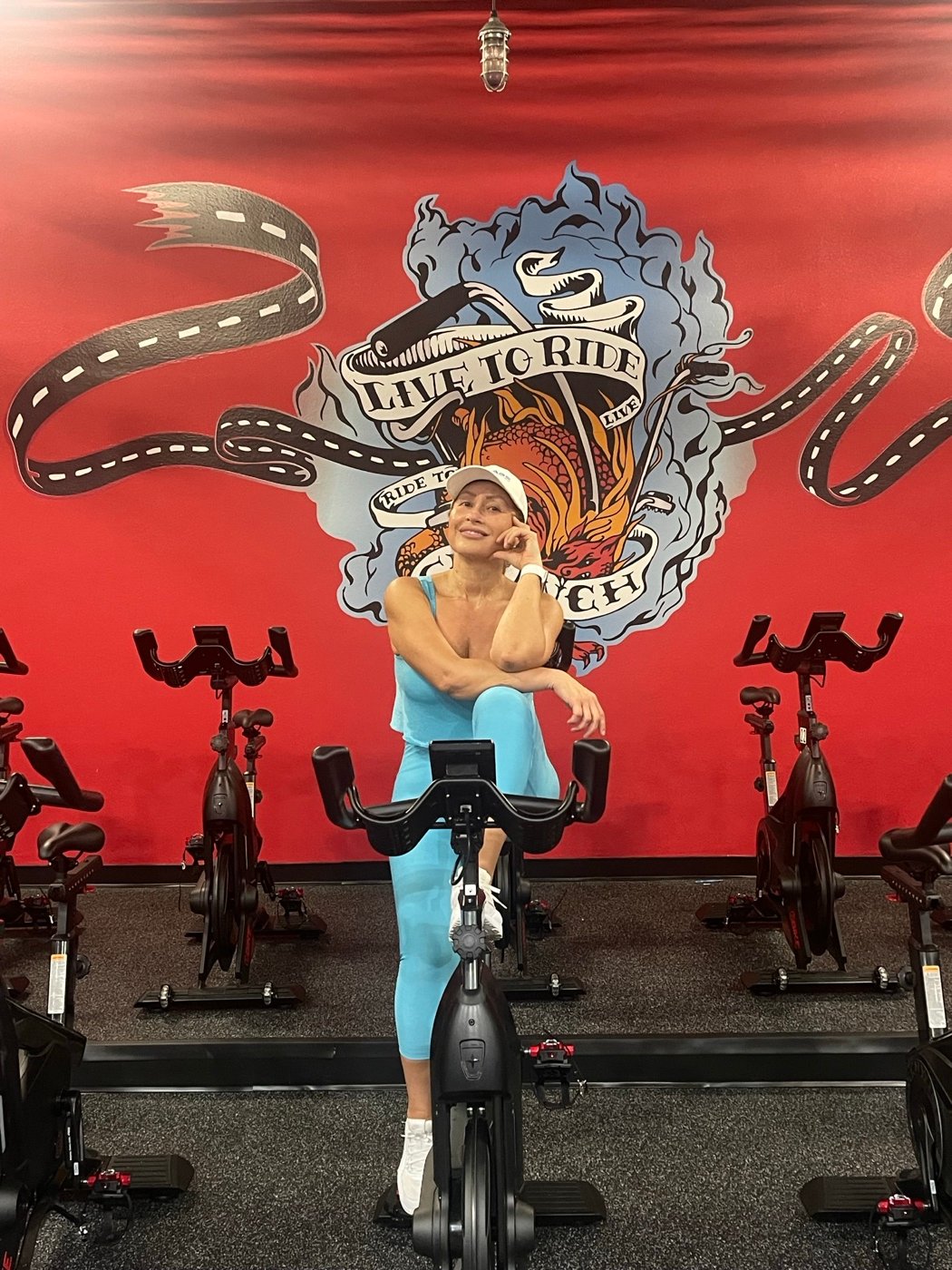 Paoli Rueda inside a colorful South Florida fitness studio